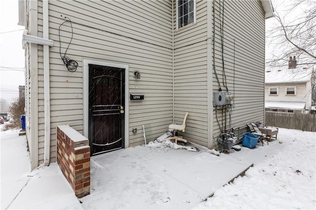 view of snow covered property entrance