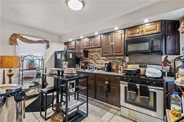 kitchen featuring black appliances, backsplash, sink, and light tile patterned floors