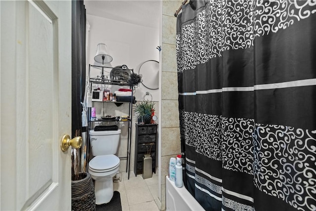 bathroom featuring shower / bath combo, tile patterned flooring, and toilet