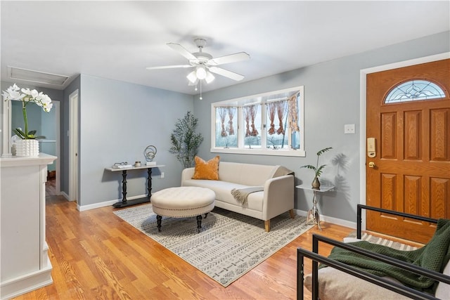 living room featuring ceiling fan and light hardwood / wood-style flooring