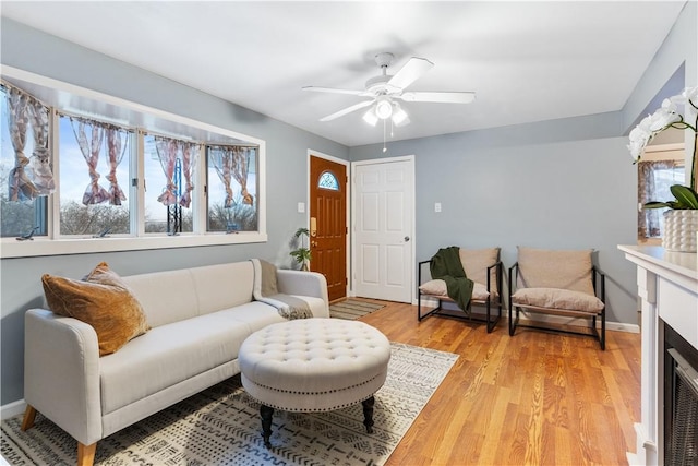 living room featuring light wood-type flooring and ceiling fan