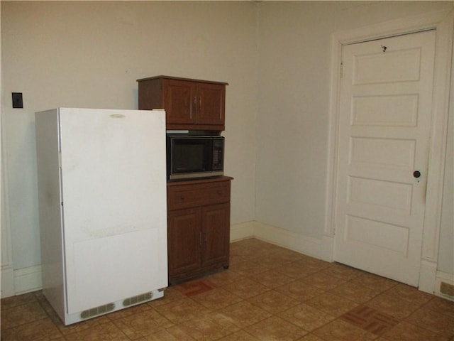 kitchen featuring white fridge