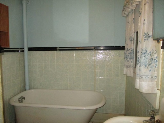 bathroom featuring tile walls, water heater, and a bathing tub