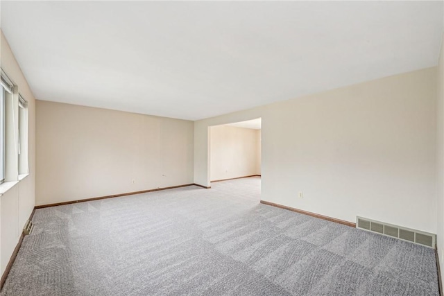 unfurnished room featuring light carpet