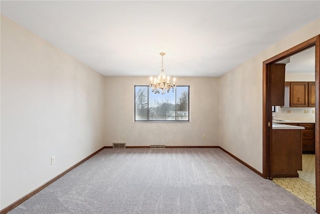 unfurnished dining area featuring light colored carpet and a chandelier