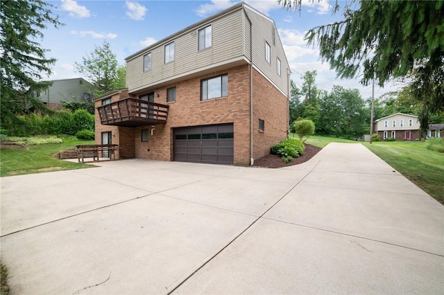 view of front of home featuring a deck, a front yard, and a garage