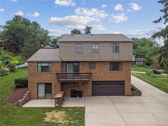 rear view of house featuring a lawn, a patio area, and a garage