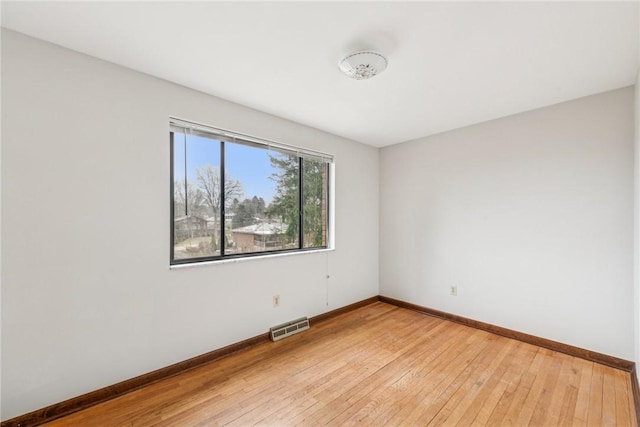 spare room featuring hardwood / wood-style flooring