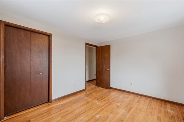 unfurnished bedroom with a closet and light hardwood / wood-style flooring