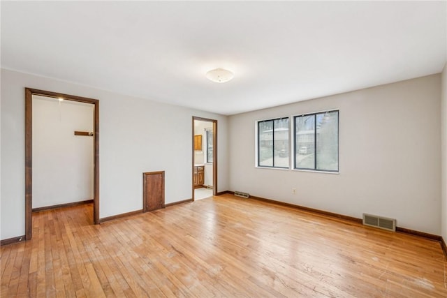 unfurnished bedroom with a closet and light wood-type flooring