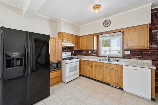 kitchen featuring black appliances, crown molding, light stone countertops, sink, and tasteful backsplash