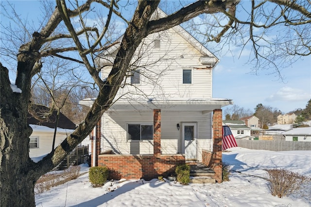 view of snow covered rear of property