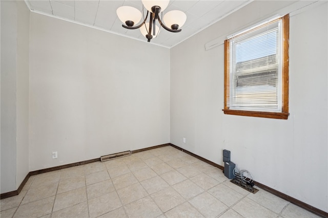 spare room featuring an inviting chandelier