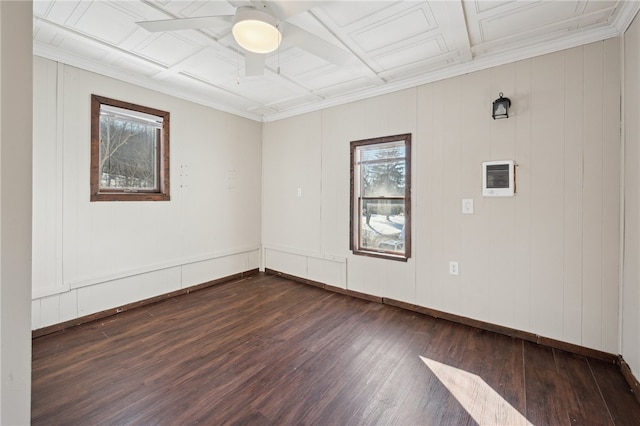 spare room featuring coffered ceiling, crown molding, dark hardwood / wood-style flooring, and plenty of natural light