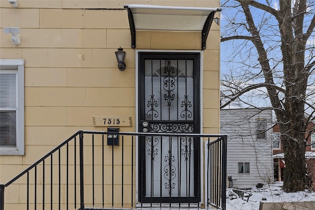 view of snow covered property entrance