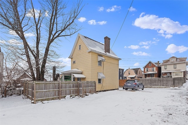 view of snow covered back of property