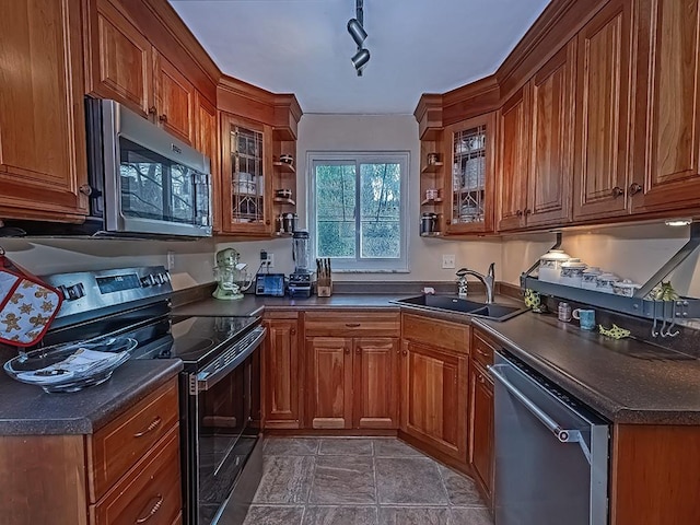 kitchen featuring stainless steel appliances, rail lighting, and sink