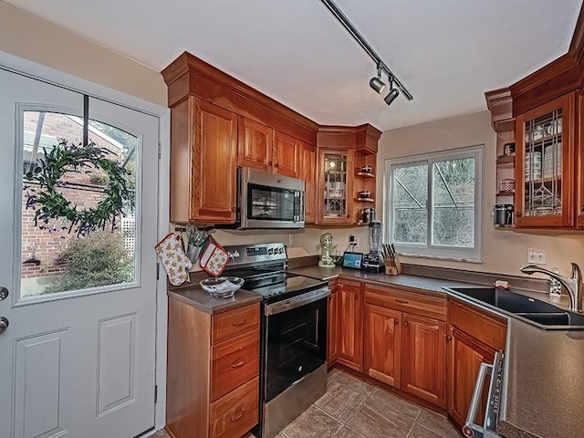 kitchen featuring sink, rail lighting, and appliances with stainless steel finishes