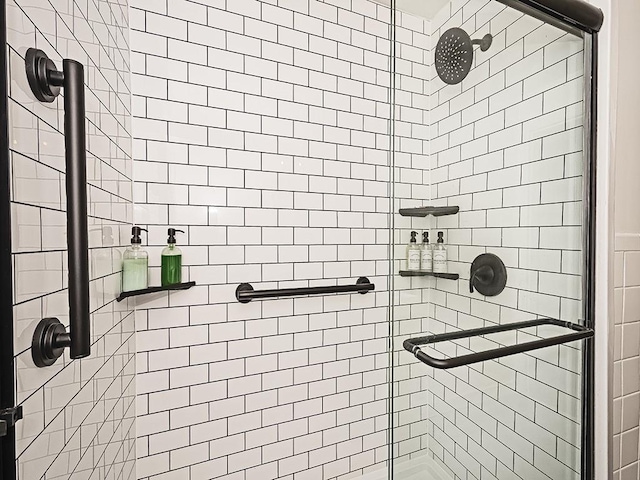 bathroom featuring a shower with shower door