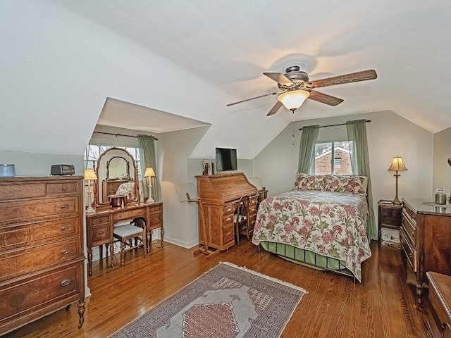 bedroom with hardwood / wood-style floors, multiple windows, ceiling fan, and vaulted ceiling