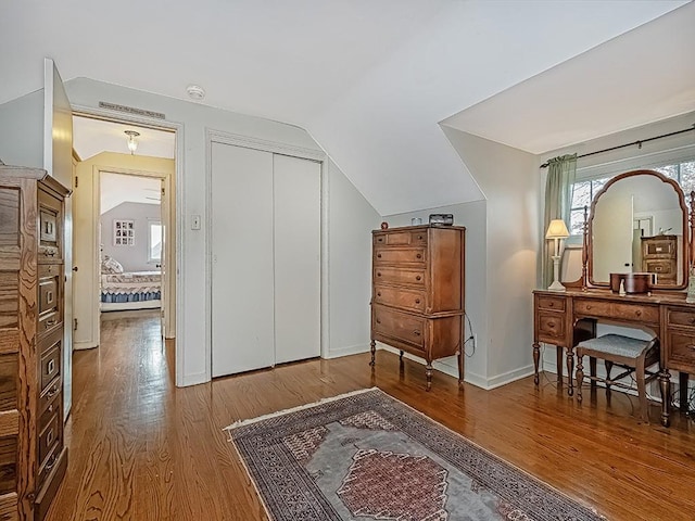 living area featuring hardwood / wood-style flooring and vaulted ceiling