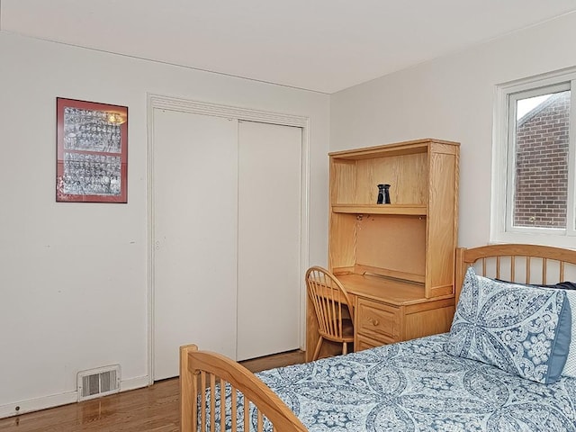 bedroom featuring hardwood / wood-style flooring and a closet