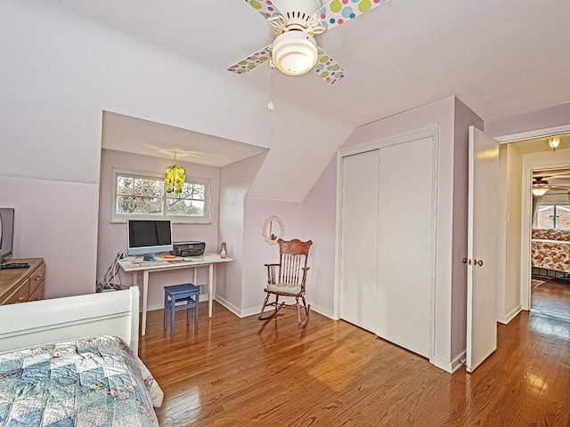 bedroom with lofted ceiling, wood-type flooring, a closet, and ceiling fan