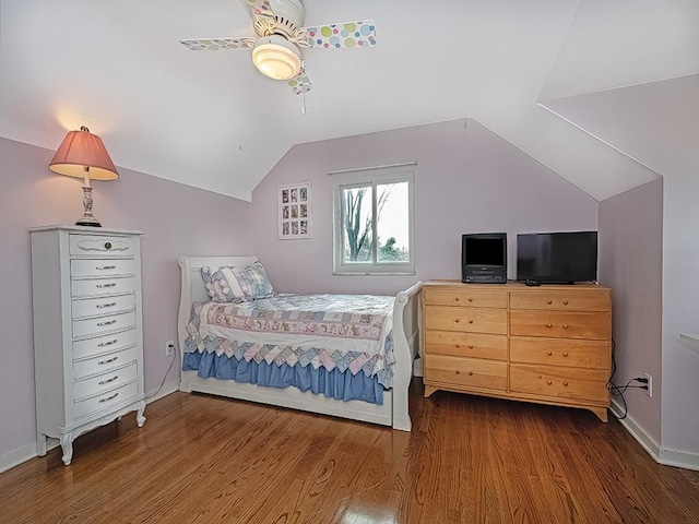 bedroom featuring ceiling fan, dark wood-type flooring, and vaulted ceiling