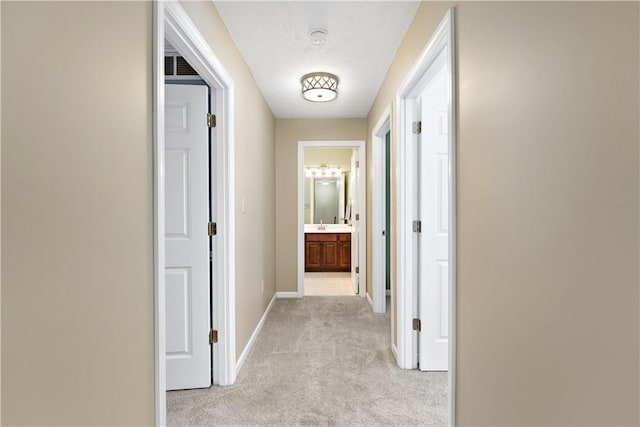 hall with light colored carpet