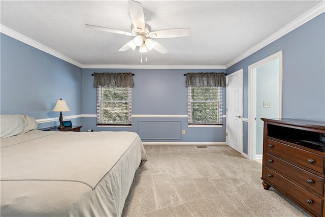 carpeted bedroom featuring ceiling fan and ornamental molding