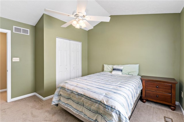 carpeted bedroom featuring lofted ceiling, ceiling fan, and a closet