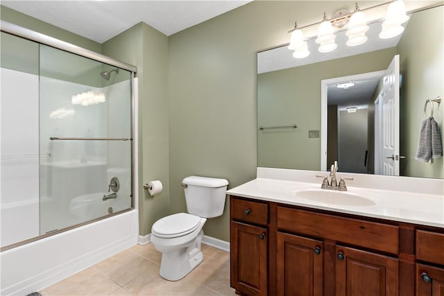 full bathroom featuring tile patterned flooring, bath / shower combo with glass door, vanity, and toilet