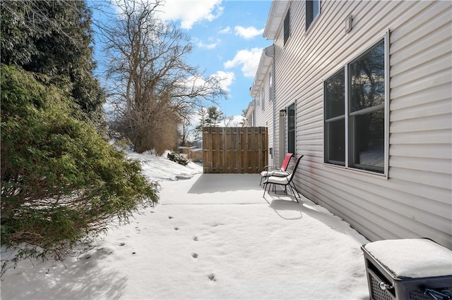 yard covered in snow featuring a patio area