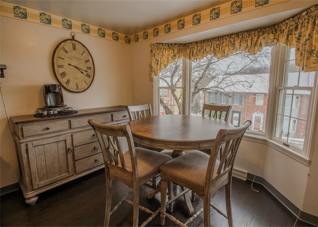 dining room featuring a healthy amount of sunlight and dark hardwood / wood-style floors