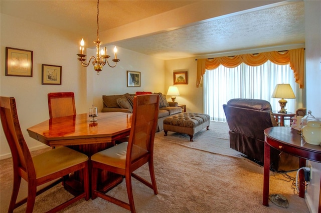 carpeted dining room featuring a textured ceiling and a chandelier