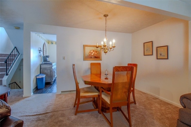 carpeted dining space with an inviting chandelier and baseboard heating