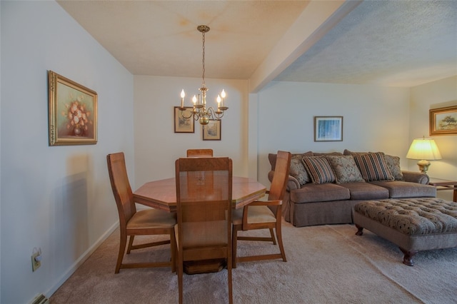 carpeted dining area with a textured ceiling and a chandelier