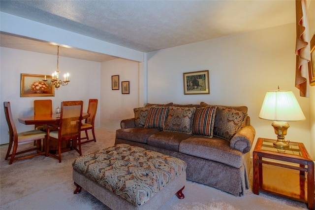 carpeted living room featuring a notable chandelier and a textured ceiling