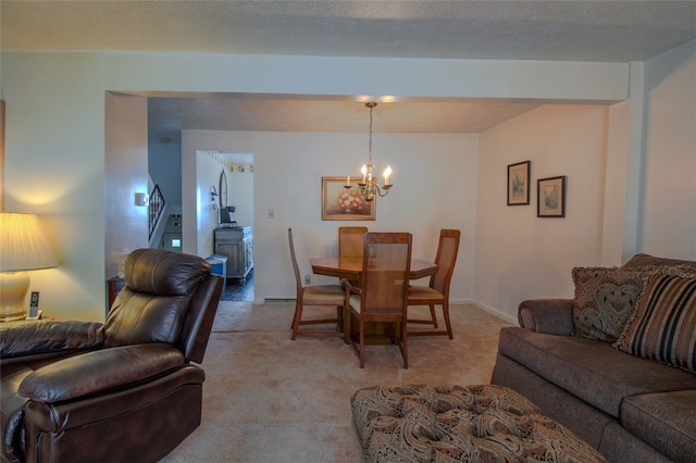 dining area featuring a textured ceiling, light carpet, and a notable chandelier