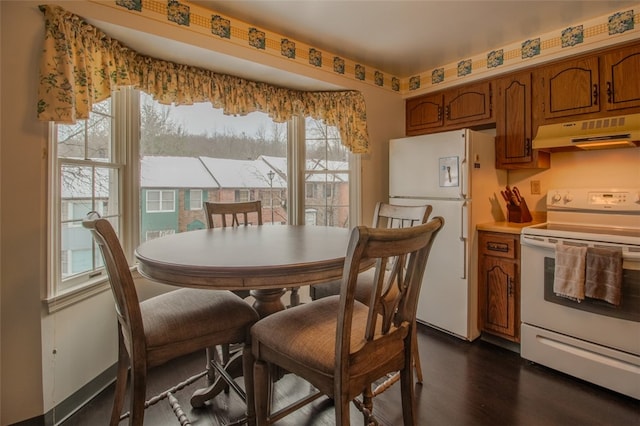 dining space with dark hardwood / wood-style flooring