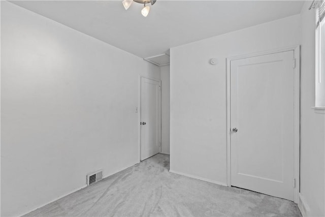 unfurnished bedroom with a closet and light carpet