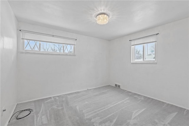 empty room with light colored carpet