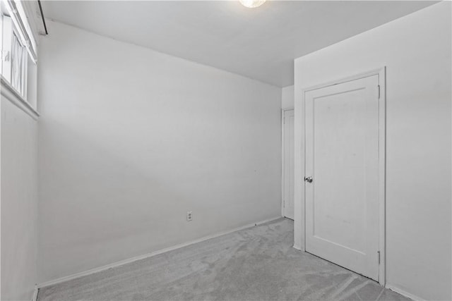 unfurnished room with light carpet