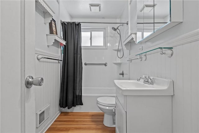 full bathroom with toilet, hardwood / wood-style flooring, shower / bath combo with shower curtain, and vanity