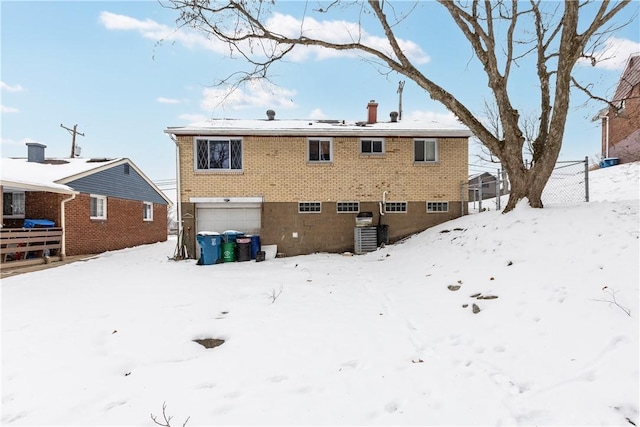 snow covered house with a garage