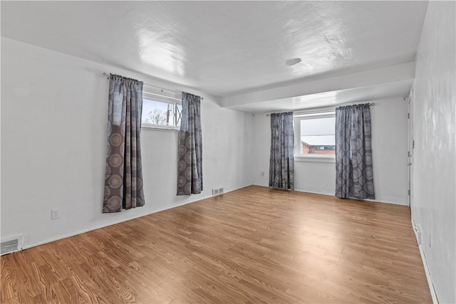 spare room with wood-type flooring