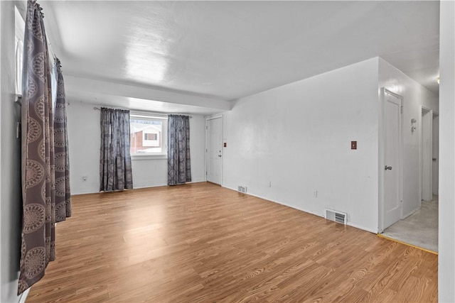 empty room with light hardwood / wood-style flooring