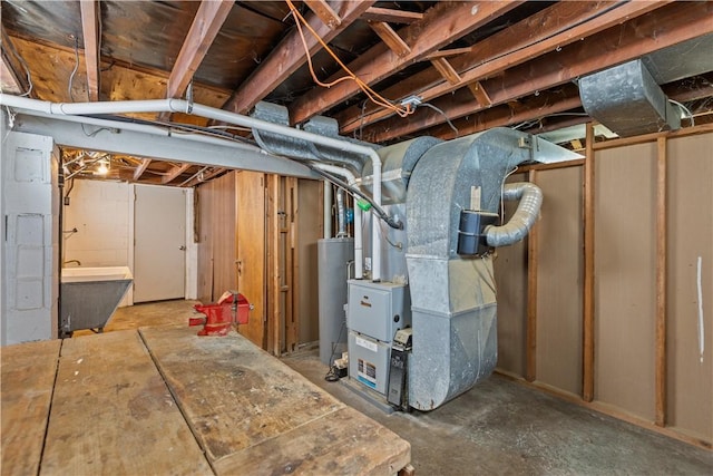 basement with sink, water heater, and heating unit