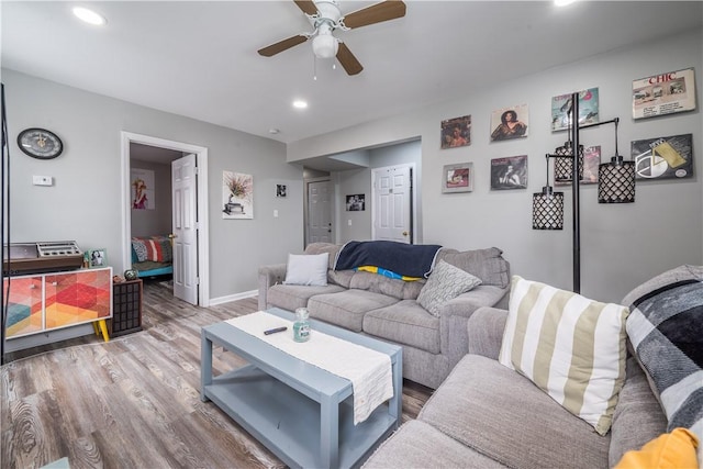 living room featuring ceiling fan and hardwood / wood-style floors