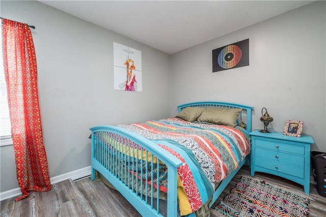 bedroom with hardwood / wood-style flooring